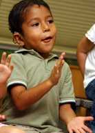 Dad little boy clapping handswith toddler