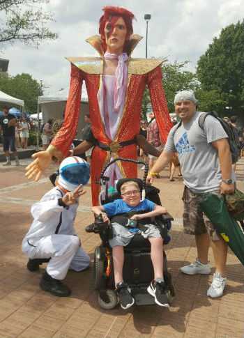 Photo of Connor in front of stature of his idol, David Bowie.