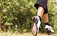 Running shoes of woman jogging on a trail