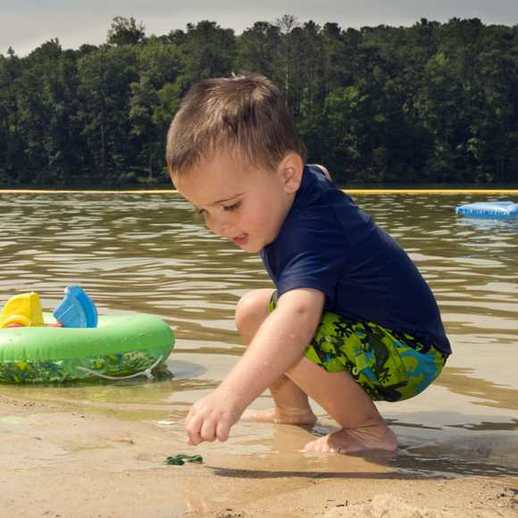 Toddler playing in sand at beach