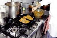 Photo of food being cooked over on a stove.