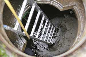 Ladder leads to a tall, half-filled cistern. 