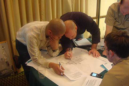 Environmental Health Specialists Brandon Parker (Bristol Bay Area Health Corporation, AK) and Paul Eaton (Maniilaq Association, AK) working on table exercise at EHTER Alaska course