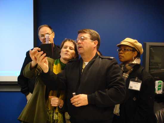 CAPT Mike Herring demonstrates a water testing kit for (L–R) CAPT Mark Miller, Lise Martel,(CDC Global Health) and Evangeline Reaves (DeKalb County Environmental Health).