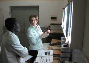 MAP Team member, Captain Mary Naughton, reviews chest x-rays with a panel physician in Ghana.