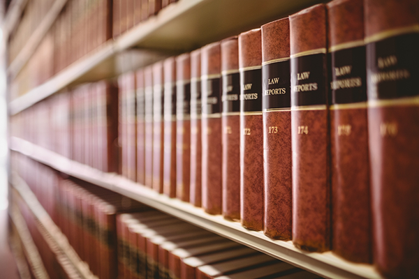 Law books sitting on a bookshelf in a library.