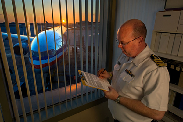 Quarantine officer at an airport reviewing data collected from an airline contact investigation. Image courtesy Greg Knobloch.