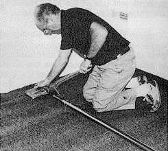 Figure 2. image of a carpet layer using a power stretcher