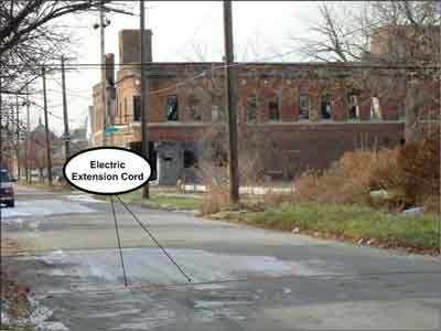 Electric extension cords crossing the road