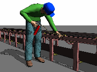 This image shows a worker bending over to grease a conveyor belt.