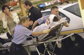 	Paramedics putting a patient into an ambulance