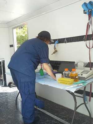 a researcher reviews data inside the portable field laboratory