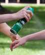 	Insect repellant being sprayed on an individuals arm