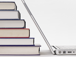 stack of books and laptop computer