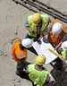 	workers looking at a building plan