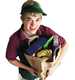 	smiling young worker holding a sack of groceries