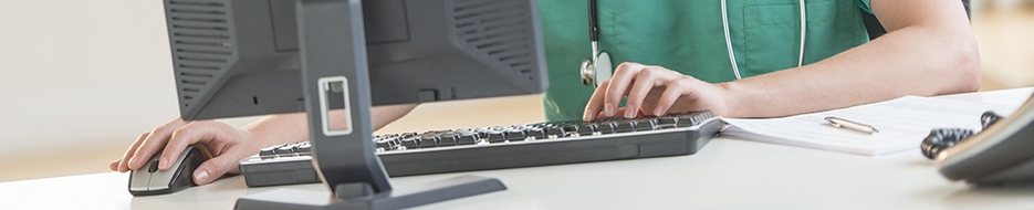 nurse typing on computer keyboard