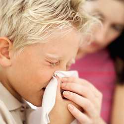 boy sneezing