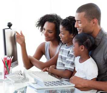 Family looking at computer.)