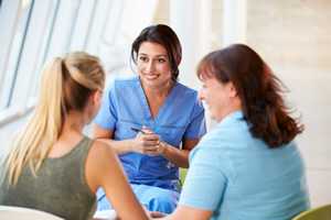 photo: doctor with teen and parent