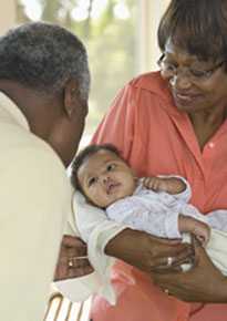 Grandparents holding an infant