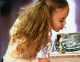 Young girl drinking from a water fountain