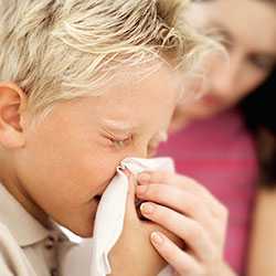 Boy blowing nose