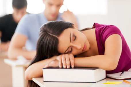 The figure above is a photograph showing an adolescent girl asleep on her desk.