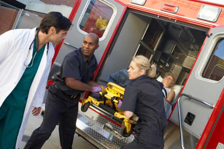 EMT technicians and a physician outside of an ambulance.