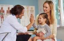 Doctor talking with mother and child