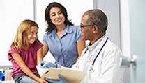 Doctor In Surgery Examining Young Girl.