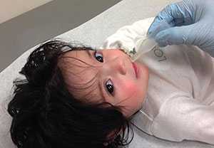 Girl receiving rotavirus vaccine