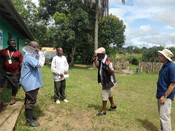 	Fig.1a. “My son is sick and needs medicine!” the Gibi District Superintendent tells the Weala Clinic Officer in Charge (OIC). (Photo credit: Miwako Kobayashi, CDC EISO. All persons provided verbal consent to being photographed.)