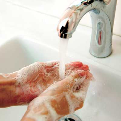 Woman washing her hands with soap