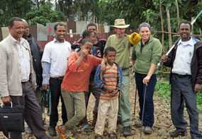 Having finished vaccinating dogs in a community, the team posed for a picture with excited young community volunteers.