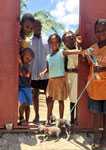 Haitian children bring their puppies to the rabies vaccination clinic.