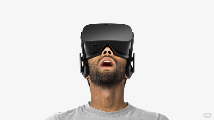 A man looks through a virtual reality headset.